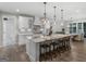 Bright kitchen featuring an island with seating, modern appliances, and stylish pendant lighting at 319 S Mount Carmel Rd, Mcdonough, GA 30253