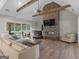 Open concept living space features vaulted ceilings, a fireplace, and a sliding glass door at 319 S Mount Carmel Rd, Mcdonough, GA 30253