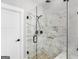 Luxurious bathroom with glass-enclosed shower featuring marble tile and modern fixtures at 319 S Mount Carmel Rd, Mcdonough, GA 30253