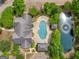 Aerial view of a house with a pool and pond surrounded by lush greenery at 307 Gladstone Dr, Mcdonough, GA 30253