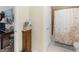 Functional bathroom area with walk-in shower featuring neutral tile, and a wooden cabinet at 307 Gladstone Dr, Mcdonough, GA 30253