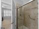 Bathroom features an updated tiled walk-in shower with grab bar and glass doors next to the en-suite bedroom at 307 Gladstone Dr, Mcdonough, GA 30253