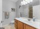 Well-lit bathroom with a vanity, sink, and a large mirror and vanity storage for added convenience at 307 Gladstone Dr, Mcdonough, GA 30253