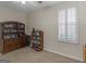 Cozy bedroom featuring a ceiling fan, a window with white shutters, and a wooden dresser with shelves at 307 Gladstone Dr, Mcdonough, GA 30253
