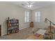 Bedroom features a fan, plantation shutters, carpet, and is currently staged as an office space at 307 Gladstone Dr, Mcdonough, GA 30253