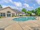 Community swimming pool with a spacious sun deck and nearby building, great for outdoor recreation at 307 Gladstone Dr, Mcdonough, GA 30253
