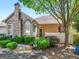 Charming home exterior featuring a stone facade, chimney, manicured landscaping, and a welcoming entrance at 307 Gladstone Dr, Mcdonough, GA 30253