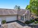 Exterior view of a home featuring a two-car garage, stone accents, and well-maintained landscaping at 307 Gladstone Dr, Mcdonough, GA 30253