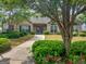 Beautiful stone home with a well-manicured lawn, bushes, and trees along a walkway leading to the front door at 307 Gladstone Dr, Mcdonough, GA 30253