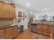 Well-lit kitchen features wood cabinets, granite counters, stainless steel appliances, and access to the living room at 307 Gladstone Dr, Mcdonough, GA 30253