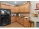 Spacious kitchen with wood cabinets, granite counters, modern appliances, wood floors, and ample storage space at 307 Gladstone Dr, Mcdonough, GA 30253