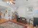 Cozy living room featuring a ceiling fan, hardwood floors, and a decorative rug, creating a warm and inviting atmosphere at 307 Gladstone Dr, Mcdonough, GA 30253