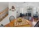 Open-concept living area with hardwood floors, a staircase, and a view of the fireplace and front door at 307 Gladstone Dr, Mcdonough, GA 30253
