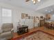 Bright living room with hardwood floors, a comfortable armchair, and plenty of natural light from the window at 307 Gladstone Dr, Mcdonough, GA 30253