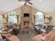 Spacious living room with a stone fireplace, vaulted ceilings, arched windows, and comfortable seating areas at 307 Gladstone Dr, Mcdonough, GA 30253