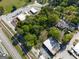 Aerial view of the neighborhood showcasing roads, parking, and trees near the property at 174 E Broad St, Fairburn, GA 30213