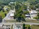 A captivating aerial view showcases this property near roads, buildings, and beautiful trees at 174 E Broad St, Fairburn, GA 30213