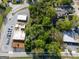 Aerial view of the property highlighting the property boundaries, mature trees, and surrounding neighborhood at 174 E Broad St, Fairburn, GA 30213
