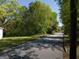 A street view showcasing this property with surrounding trees and a paved road at 174 E Broad St, Fairburn, GA 30213