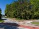 Street view showcasing this property's surrounding trees and a paved road at 174 E Broad St, Fairburn, GA 30213