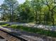 A pleasant street view featuring mature trees, and a glimpse of charming homes in a serene residential area at 174 E Broad St, Fairburn, GA 30213