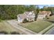 Aerial view of a two-story home features well-manicured lawn and an extended driveway at 225 Briarsweet Way, Fayetteville, GA 30215