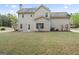 Backyard with siding and manicured flowerbeds at the back of the home at 225 Briarsweet Way, Fayetteville, GA 30215