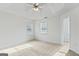 Spacious bedroom featuring neutral carpet, a ceiling fan, and access to a walk-in closet at 225 Briarsweet Way, Fayetteville, GA 30215