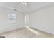 Bright bedroom featuring a vaulted ceiling, neutral carpet, and a large window for ample natural light at 225 Briarsweet Way, Fayetteville, GA 30215