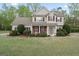 Charming two-story home featuring manicured landscaping, a welcoming entrance, and a classic architectural design at 225 Briarsweet Way, Fayetteville, GA 30215