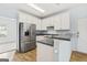 Bright kitchen with white cabinets, stainless steel appliances, and breakfast bar at 225 Briarsweet Way, Fayetteville, GA 30215