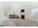Bright living room featuring a fireplace, neutral carpeting, and abundant natural light at 225 Briarsweet Way, Fayetteville, GA 30215