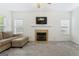 Cozy living room with a fireplace, plush carpeting, and a neutral color palette at 225 Briarsweet Way, Fayetteville, GA 30215