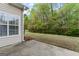 View of the backyard patio with a view of the natural surrounding greenery at 225 Briarsweet Way, Fayetteville, GA 30215