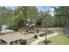 The community playground features swings, a slide, and mature trees at 225 Briarsweet Way, Fayetteville, GA 30215