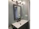Modern bathroom vanity with gray cabinets, white countertop, and sleek black hardware at 116 Stewart Ave, Jonesboro, GA 30236