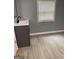 Neutral bathroom with a modern vanity with a black faucet and a large mirror at 116 Stewart Ave, Jonesboro, GA 30236