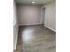 Neutral bedroom with modern ceiling fan, gray walls and wood-look floors at 116 Stewart Ave, Jonesboro, GA 30236