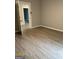 A bedroom with light gray walls and light-colored vinyl plank flooring throughout at 116 Stewart Ave, Jonesboro, GA 30236