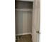 An empty closet with a sturdy rod to hang clothes with wood-look flooring at 116 Stewart Ave, Jonesboro, GA 30236