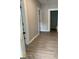 Neutral hallway with wood-look floors, leading to other rooms of the home at 116 Stewart Ave, Jonesboro, GA 30236