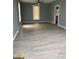 Light-filled living room with wood-look floors, neutral walls, and a modern ceiling fan at 116 Stewart Ave, Jonesboro, GA 30236