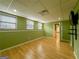 Finished basement featuring hardwood floors, multiple windows, and a wall-mounted TV at 3195 Vickery Ne Dr, Marietta, GA 30066