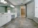 Spacious bathroom featuring double vanity, gray tile floors, and ample lighting at 3195 Vickery Ne Dr, Marietta, GA 30066