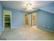 Bright bedroom with blue walls, ceiling fan, carpeted floors, closet and bathroom access at 3195 Vickery Ne Dr, Marietta, GA 30066
