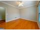 Bright bedroom featuring hardwood floors, ceiling fan, neutral walls and white trim at 3195 Vickery Ne Dr, Marietta, GA 30066