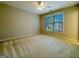 Neutral bedroom featuring carpeted floor and a window with views of the neighborhood at 3195 Vickery Ne Dr, Marietta, GA 30066