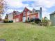 Charming two-story brick home with a two-car garage and a large, well-maintained front lawn at 3195 Vickery Ne Dr, Marietta, GA 30066