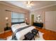 Modern bedroom with neutral colors, hardwood floors, a large window, and ample closet space at 3195 Vickery Ne Dr, Marietta, GA 30066