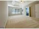Bright main bedroom featuring tray ceiling, fan, and doorways to adjacent bath at 3195 Vickery Ne Dr, Marietta, GA 30066